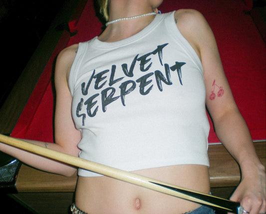Person wearing a 'Velvet Serpent' tank top holding a pool cue.